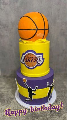 a three tiered cake with a basketball on top and the words happy birthday written below it