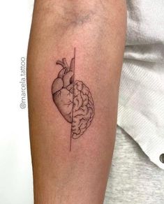 a person with a tattoo on their arm that has a drawing of a heart and brain