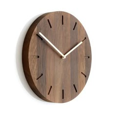 a wooden clock with white hands on a wall