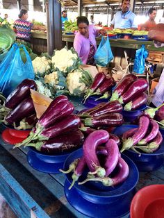 purple eggplant and other vegetables on blue plates