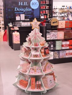 a christmas tree made out of cards and other items in a department store display case