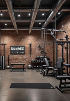 an empty gym with benches, exercise mats and weights on the floor in front of a brick wall