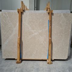 two marble slabs sitting next to each other in a room with wooden frames on the floor