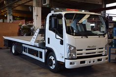 a large white truck parked in a garage