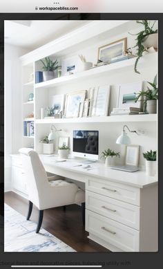 a white desk and chair in a room with bookshelves on the wall behind it