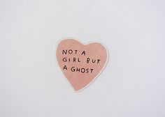 a pink heart shaped sticker with the words not a girl but a ghost written on it