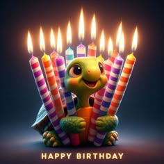 a tortoise sitting in front of candles with the words happy birthday written on it