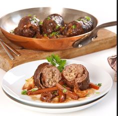 a plate with meatballs and vegetables on it next to a skillet filled with sauce