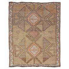 an antique rug with geometric design on the front and sides, in beige tones is shown