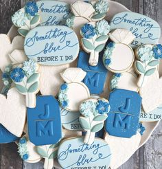 decorated cookies with blue and white frosting on a platter that reads something i do, something i do, something i do before i do