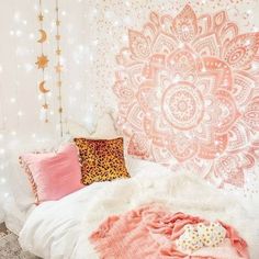 a pink and white bedroom with a large tapestry on the wall