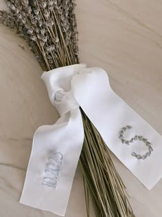 a bunch of dried flowers sitting on top of a white table cloth with the word love written on it