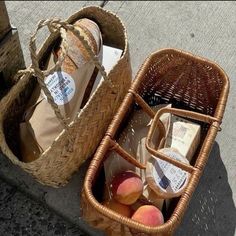 two baskets filled with food sitting next to each other on the side of a road