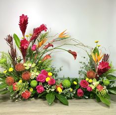 an arrangement of flowers arranged on a table