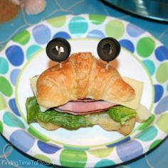 a croissant sandwich with an eyeball on it's face and eyes