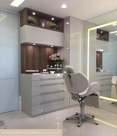 a salon chair sitting in front of a mirror and counter top with flowers on it