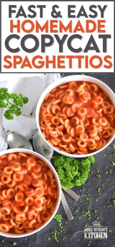 two white bowls filled with pasta and sauce on top of a black table next to parsley