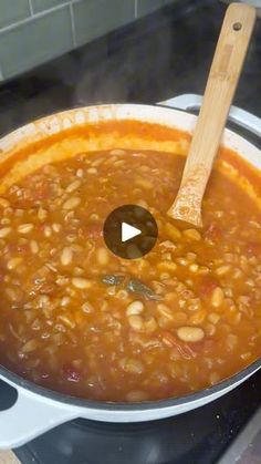 a pot filled with beans on top of a stove