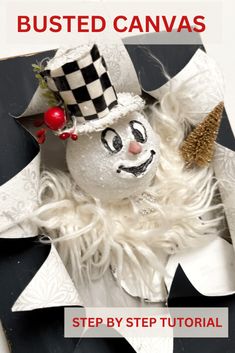 an ornament with a top hat and feather on it is in the shape of a snowman