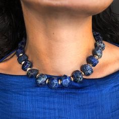 A Chunky Collar of rich Lapis Lazuli with a snake clasp. Lapis lazuli has been associated with royalty, strength and courage, wisdom and intellect, friendship, and truth. In ancient Egypt, it was powdered and worn around the eyes to improve eyesight, and some today consider it an aid to balancing the brow chakra, which influences vision and hearing. Brass beads in between each stone bead are plated in 18K gold. 16" long. All orders over $50 ship for free within the USA. All orders usually ship within 24 hours from NYC. To Improve Eyesight, Brow Chakra, Temple Necklace, Eye Sight Improvement, Lapis Necklace, Lapis Lazuli Necklace, Brass Beads, A Snake, Fine Jewellery Necklace