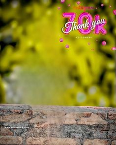 a brick wall with the words thank you in pink and white on it, against a green background