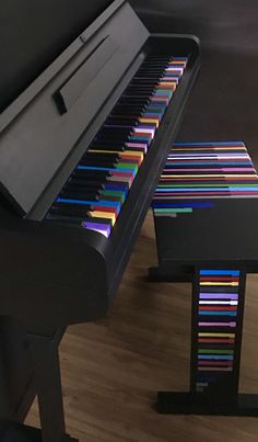 a black piano with colorful strips on it