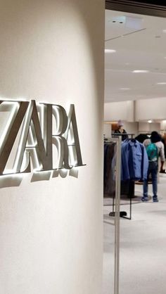 a sign that says zara hanging on the side of a wall