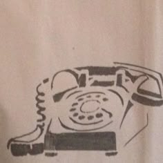 an old fashioned phone drawn on a white t - shirt