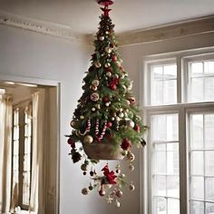 a decorated christmas tree hanging from the ceiling