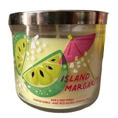 a candle that is decorated with fruit and has the words island margarita written on it