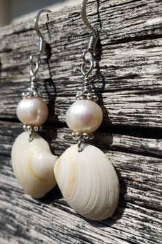 Add a touch of class to your beach vibes with these simple yet sophisticated earrings.  Lustrous Baroque freshwater pearls provide the perfect accent for these dainty seashells. Approximately 2 inches in length, this pair is super lightweight and go with everything from bikinis to jeans to business casual.  I personally handpicked these shells from Orange Beach, Alabama and couldn't wait to get back to Dallas to start designing. Each pair is matched based on color striations and shell size, then Elegant Adjustable Jewelry For Beach Season, Elegant Handmade Shell Strand, Summer Gift White Pearl Earrings, Elegant Pearl White Shell For Beach, Elegant Pearl White Jewelry For Beach, Beach Shell With Pearl Drop In Ocean Style, White Shell Dangle Pearl Earrings, White Shell Pearl Dangle Earrings, White Dangle Shell Pearl Earrings