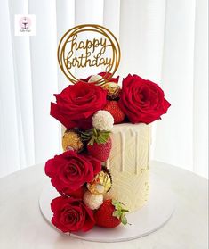 a birthday cake decorated with strawberries and roses