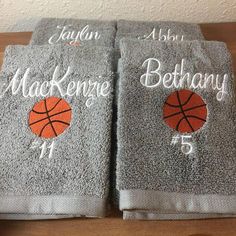 two gray towels with basketballs on them and the name of each towel is shown