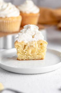 a cupcake with white frosting on a plate