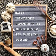 a sign that says happy thanksgiving and some other things on the ground next to it