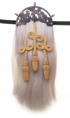 a long white wig with some beads hanging from it's side