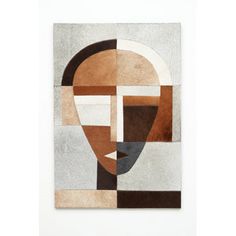 a piece of art that looks like a face on a white background with brown and tan colors