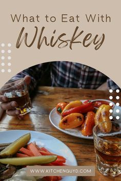 a person sitting at a table with food on it and the words, what to eat with whiskey