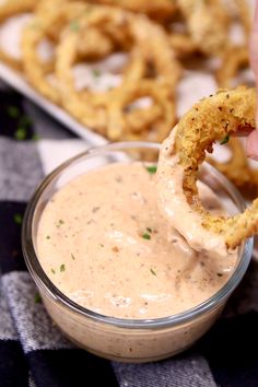 an onion rings dipping sauce in a glass bowl with the text, outback copycat blooming onion sauce