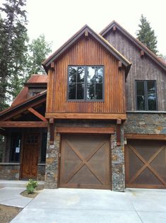 a large house with two garages in front of it