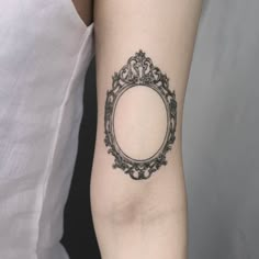 a black and white photo frame tattoo on the arm