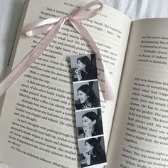 an open book with four pictures on it and a pink ribbon tied around the page