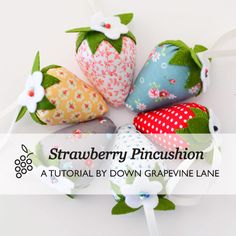 four strawberry pincushion sitting on top of each other in the middle of a circle