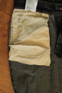 the back pocket of a pair of jeans with a tag on it's side