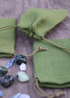 some rocks are laying on the ground next to a green cloth bag and drawsewl