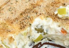 a close up of a casserole dish with cheese and vegetables