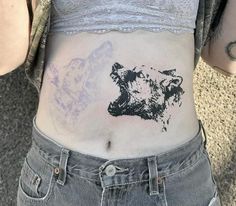 a woman with a bear tattoo on her stomach