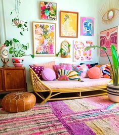 a living room filled with furniture and pictures on the wall above it's colorful rug