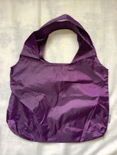 ChicoBag Vita Reusable Shoulder Tote Shopping Bag. Color : Purple Bag: 19"w x 13"h (48cm w x 33cm h) Pouch: 3"w x 5"h (8cm w x 13cm h) Weight: 2.0 oz. / .125 lbs. Replaces 1560 Single-Use Bags Throughout Its Life Shoulder-Style Tote 40 Pound Carrying Capacity Entire Bag Stuffs Into Built-In Pouch For Convenient Storage Machine Washable Shipped with USPS First Class Package You are purchasing item as pictured. Please ask any question before purchasing. We ship the item from smoke free / friendly Reusable Nylon Bags For Everyday Use, Casual Reusable Nylon Bag, Everyday Reusable Nylon Bags, Recyclable Nylon Bags For Daily Use, Purple Nylon Bag For Outdoor Use, Purple Nylon Bags For Outdoor Use, Purple Nylon Bag For Outdoor, Purple Nylon Bags, Large Capacity Purple Nylon Bag