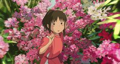 a girl standing in front of pink flowers with her hand up to her chest and looking at the camera